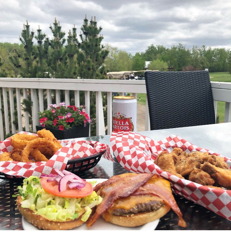 Image of the Cheeseburger, Onion Rings and Wings and beverage at the Clubhouse Restaurant in Lorette.