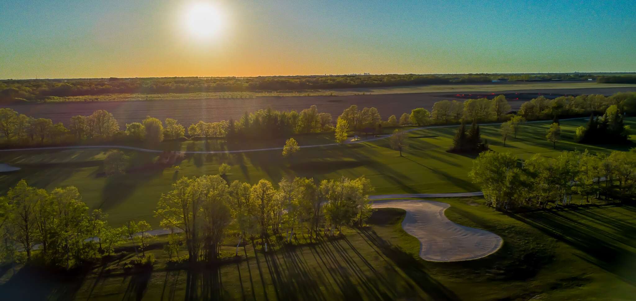 Overhead drone view of the 2nd Hole bunker with the sun starting to set in the background.