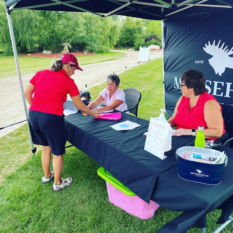 Women signing up for member event at Lorette Golf Course